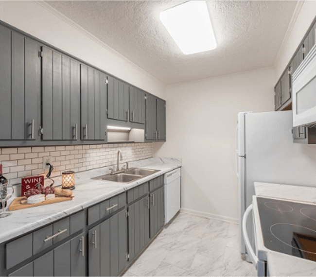 Fully equipped kitchen with all essential implements included, such as microwave, fridge & kitchen ware