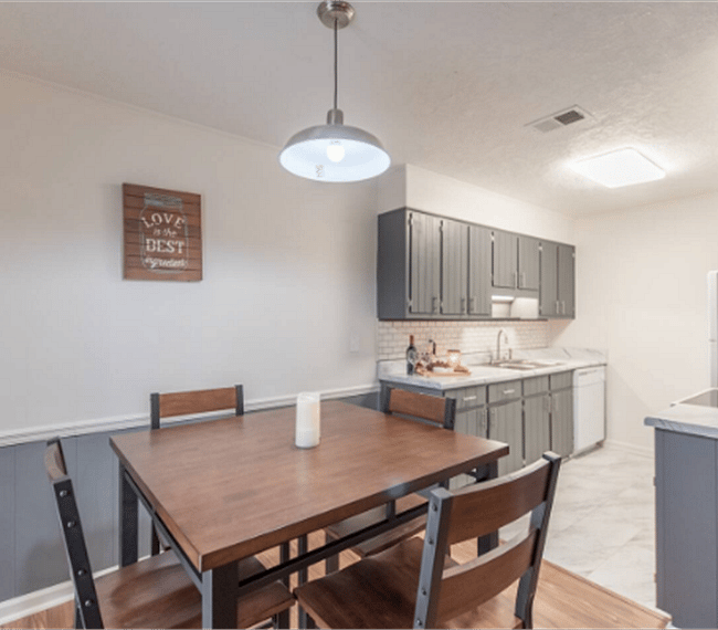 Dining area with squared table of 4 spots, right next to the kitchen