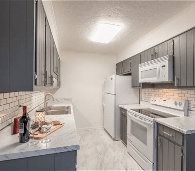 Fully equipped kitchen with all essential implements included, such as microwave, fridge & kitchen ware