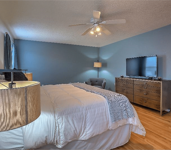 1st masters bedroom with queen sized bed, lovely night stands, wide drawers, TV & a stuffed sofa
