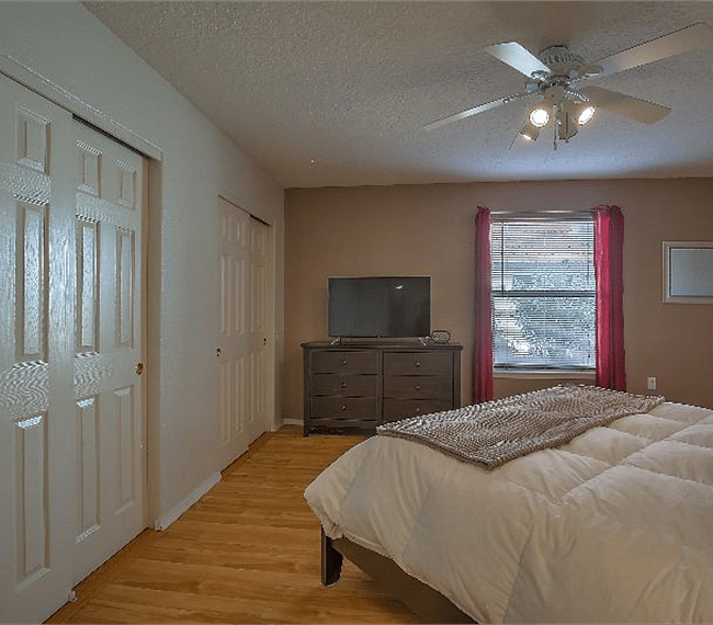 2nd masters bedroom with king sized platform bed, drawers, TV, wide wardrobe & personal bathroom