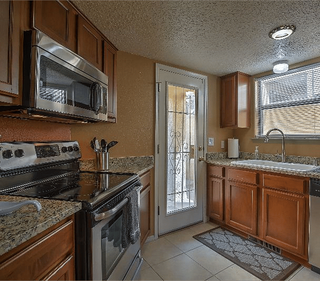 Fully equipped kitchen with all esential implements such as microwave, stove & coffee maker