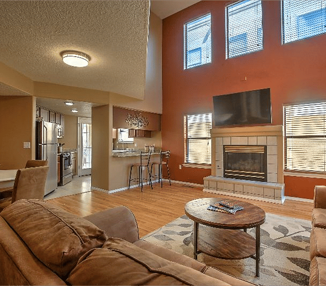 Spacious living room with 2 lawson style sofa, fireplace, carpet & flat table