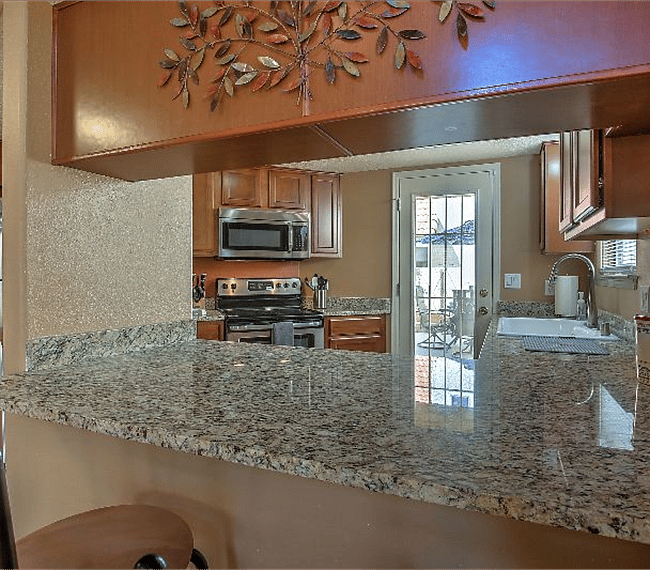 Fully equipped kitchen with all esential implements such as microwave, stove & coffee maker