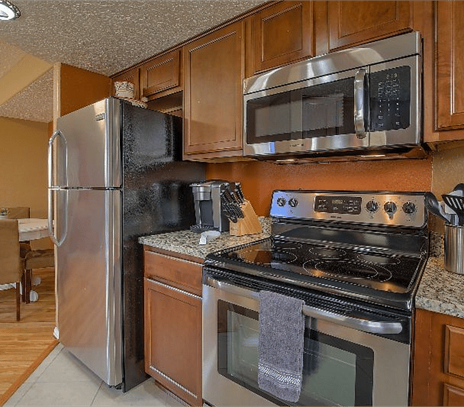 Fully equipped kitchen with all esential implements such as microwave, stove & coffee maker