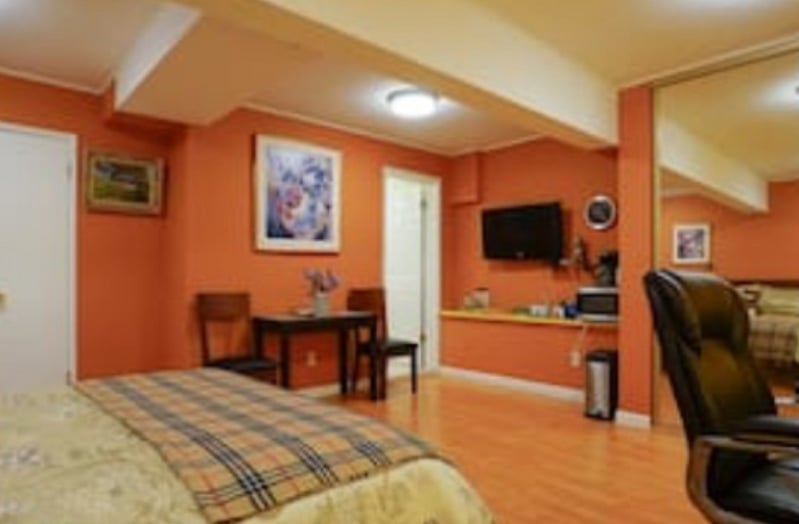 Cozy and bright bedroom with queen sized bed, work station, aditional sitting area, TV & amazing view