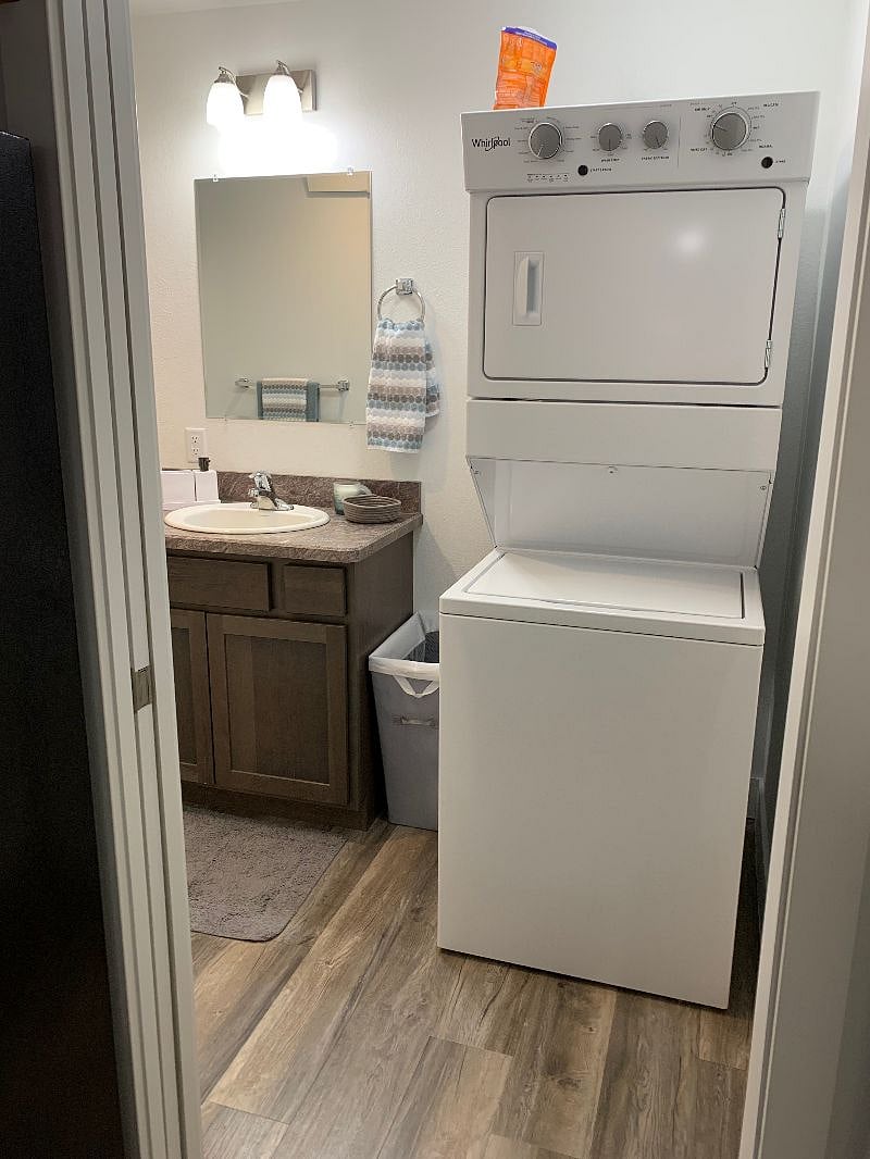 Stacked large tub washer/dryer in bathroom