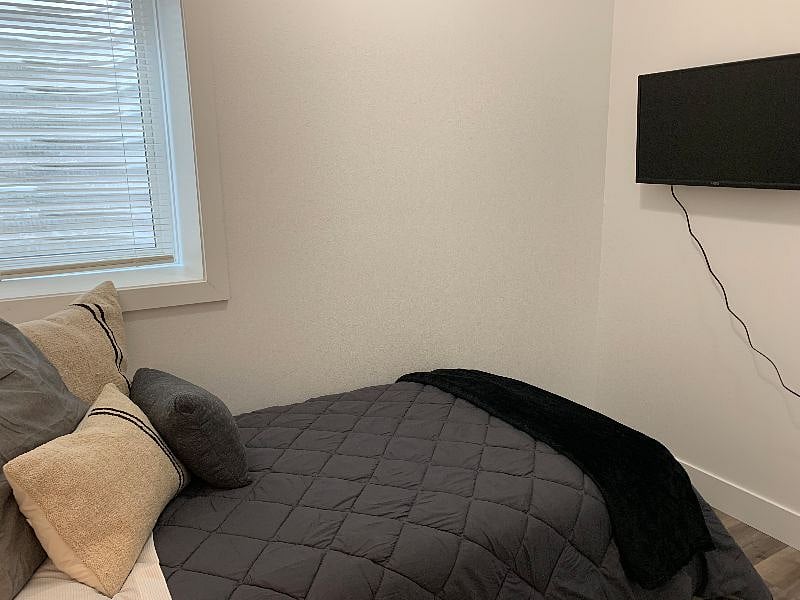 Separate tv mounted in second bedroom. (Can be taken off wall and put on stand on dresser in queen bedroom.)
