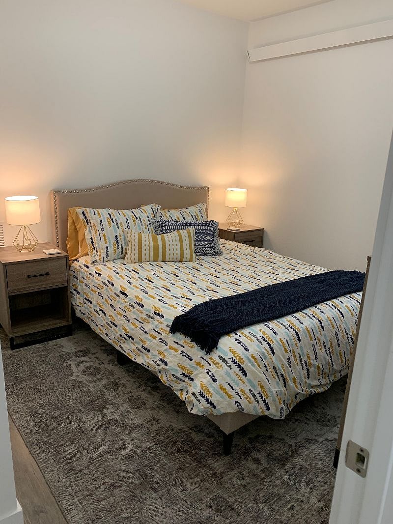 Queen bedroom with closet, dresser and nightstands for storage/clothing