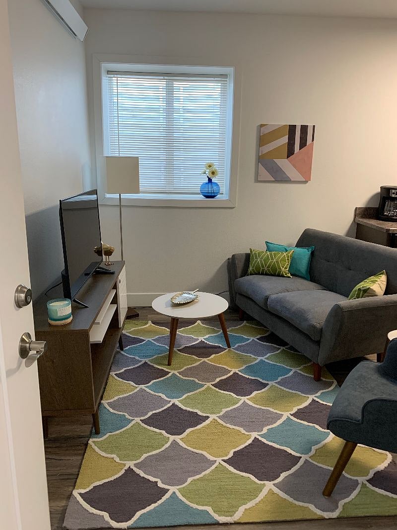Clean, modern living room with large egress window for lots of natural light.