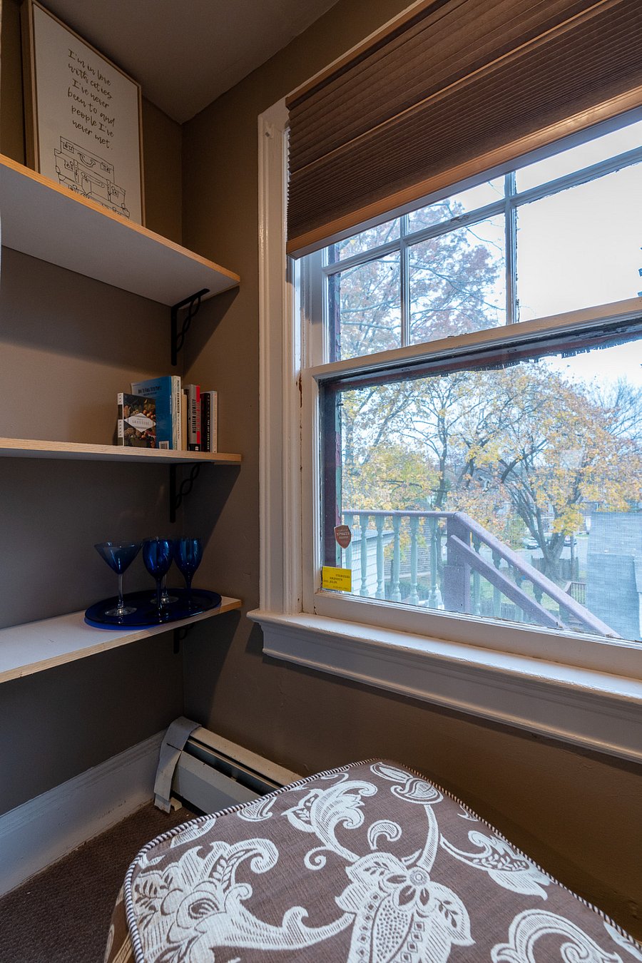 comfy ottoman, book shelves and small drink set up