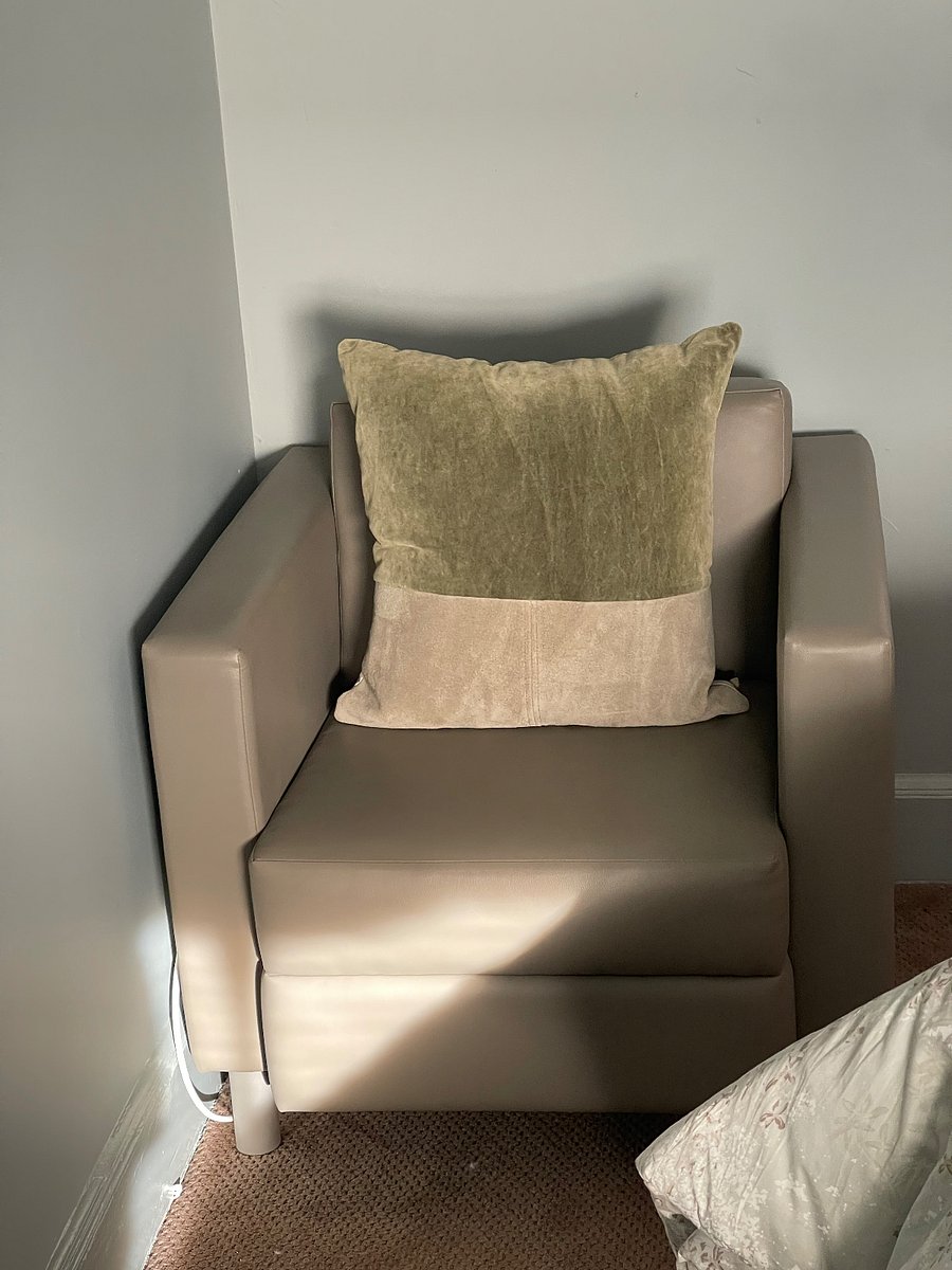 Green bedroom chair right by the television