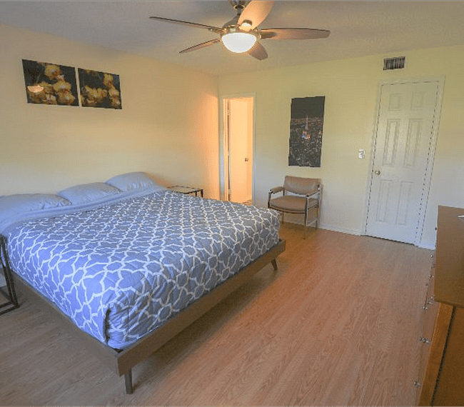 Spacious master bedroom suite with calming decor.