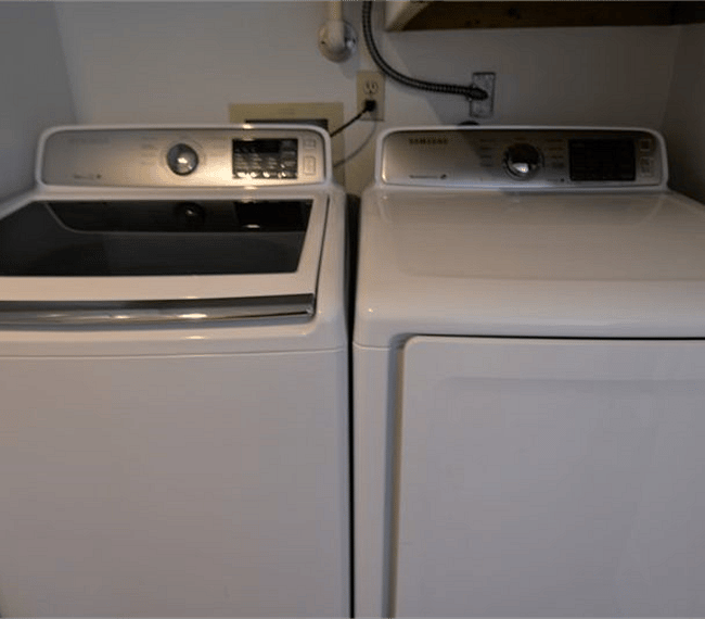 Newer high-efficiency large capacity washer and dryer in suite.