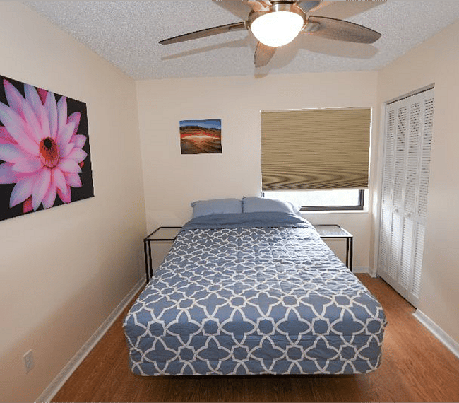 Comfortable guest bedroom furnished with dresser, LCD TV, adjustable queen bed.