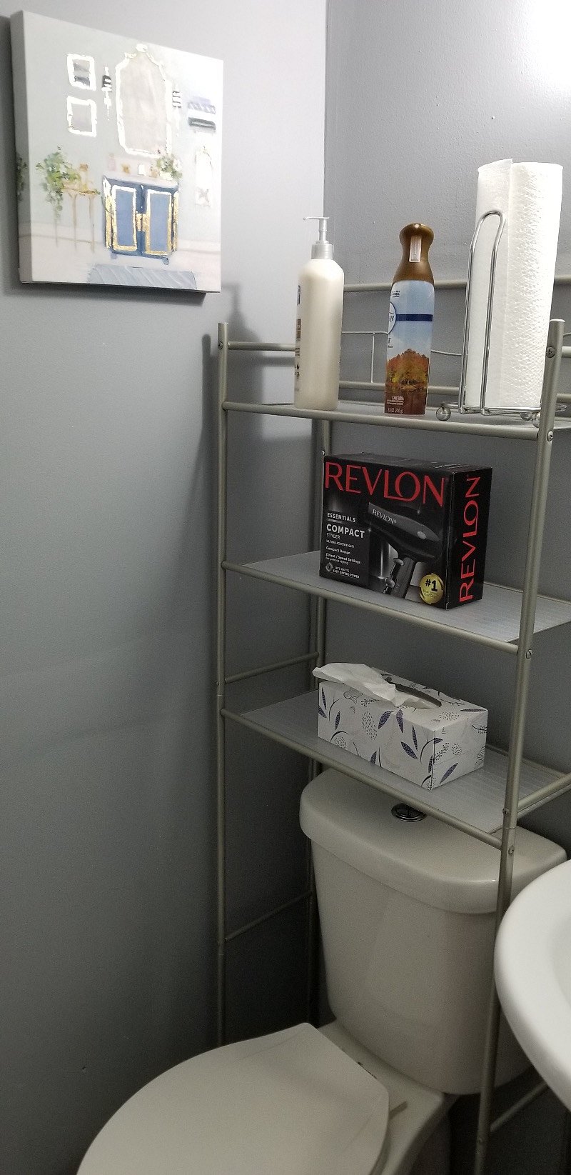 Newly renovated Bathroom with tile flooring, dual flush commode, new vanity, and glistening white tile shower with adjustable handheld shower head.