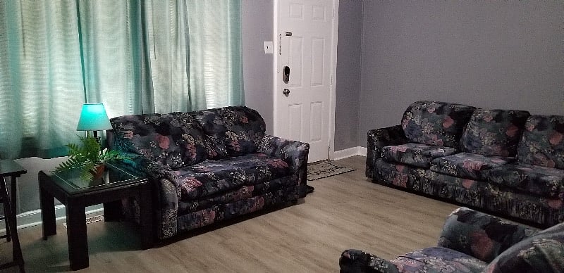 Living Room - Features soft full size sofa, love seat and chair, (2) lamps (1) with colored smart bulb and smart TV that can be voice controlled by Google Assistant.