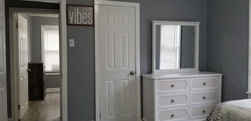 The White Room - Features (2) soft but firm Twin Beds with plush pillows, a full dresser with mirror, night stand & lamp with colored smart bulb controlled by Google Assistant.