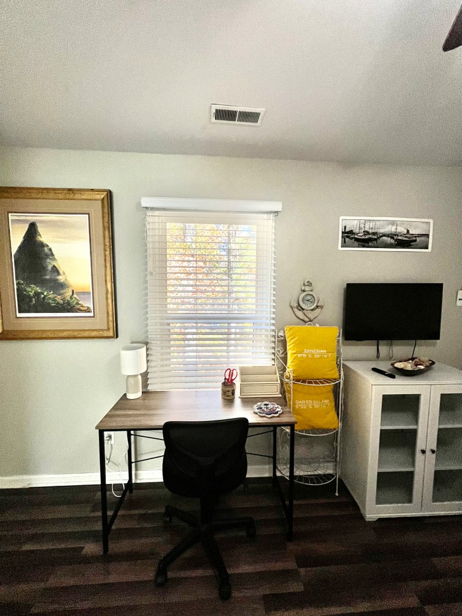 full size bed with working space for laptop that looks out to trees