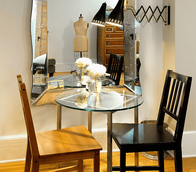 Writing table by vintage mirror.