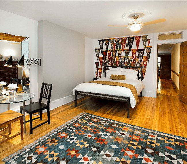 Comfortable queen bed with view of hall.