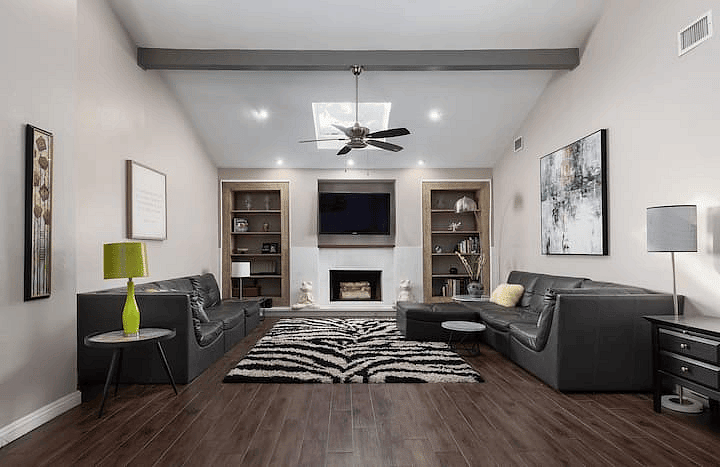 Light and airy living space with skylight and gas log fireplace