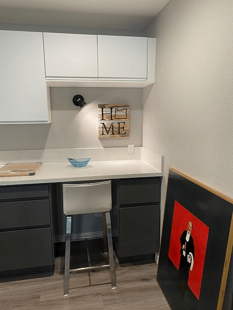 A well-lit desk area is available at far end of kitchen