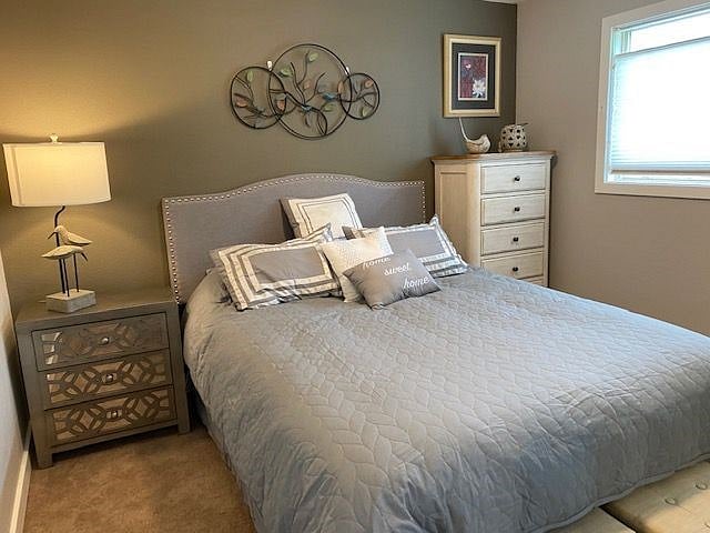 Smaller bedroom features Queen bed, luxury linens, night stand, dresser, luggage rack and inviting decor