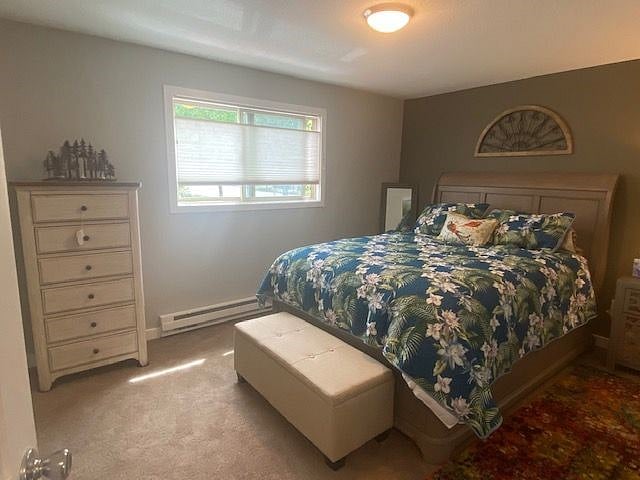 Larger bedroom features queen size bed, 500+thread-count sheets, dresser and a candle-(flame-less) lit forest scene to create a warm and inviting feel to your room