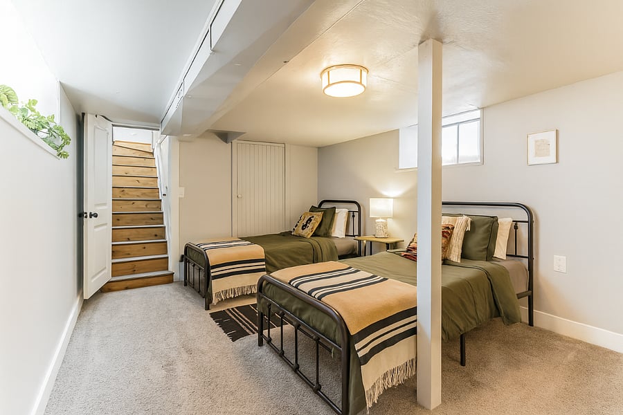 Settle in downstairs with two twin beds, soft lighting, and thoughtful decor for a comfortable stay.