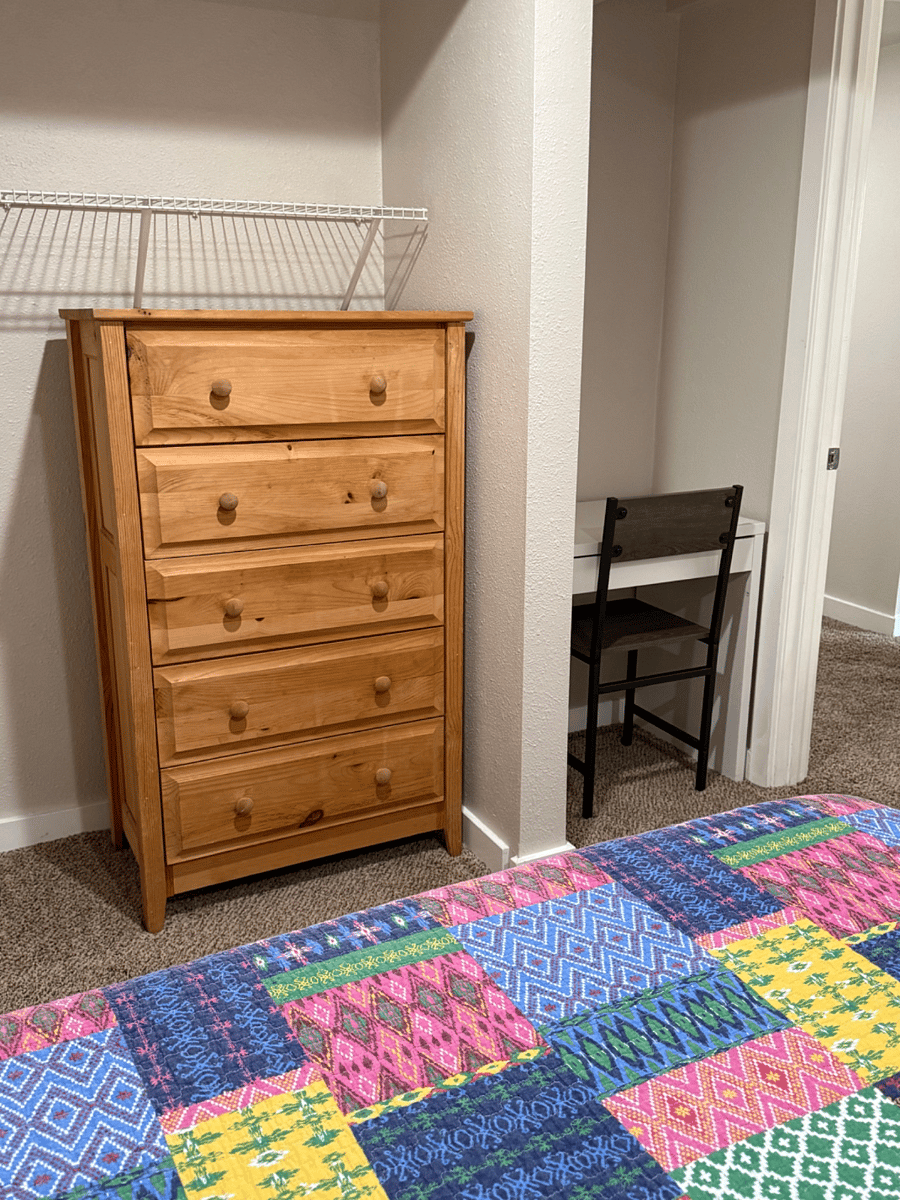 Dedicated workspace, full-size dresser, and open closet provide everything need ed for a comfortable extended stay