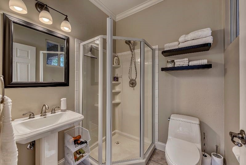 Sparkling shower, well stocked towels and toiletries in bathroom