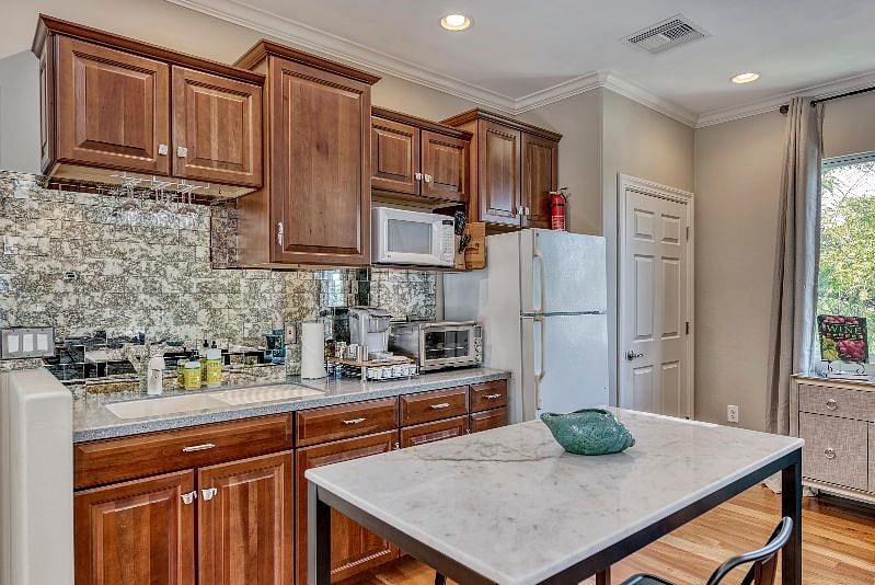 Marble Island doubles as prep surface and eating area. Also, dining table outside on balcony 