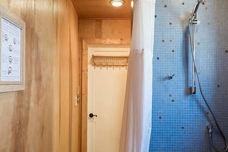 Lovely blue tiles in bathroom as well as birch wood paneling.