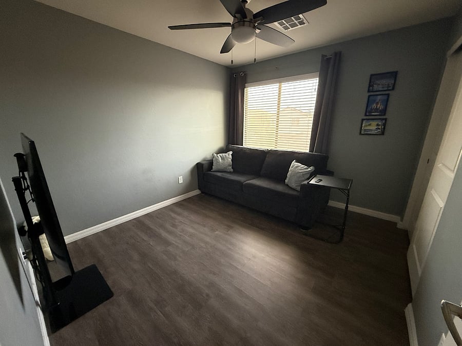 Separate living room area, large TV with Apple TV box, pull out couch