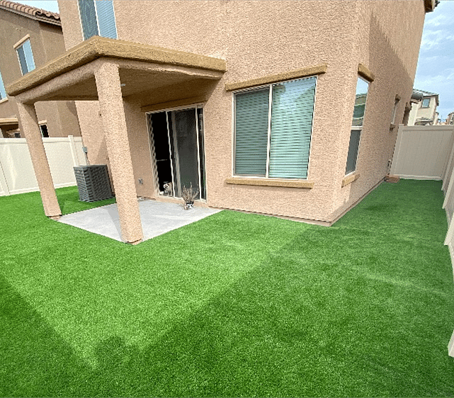 Fenced in backyard with turf and patio seating (not pictured)