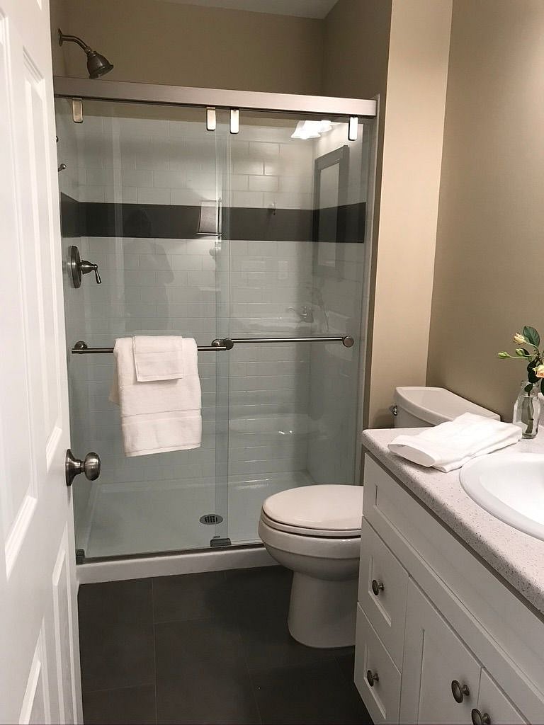 Full bath with tile floor and sink-base cabinet storage. Bath located across from lighted closet.