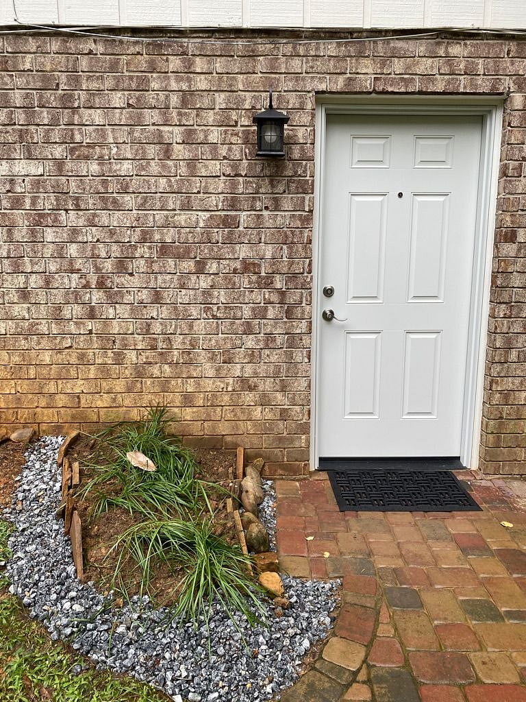 Entrance to apartment, lighted area with two locks.