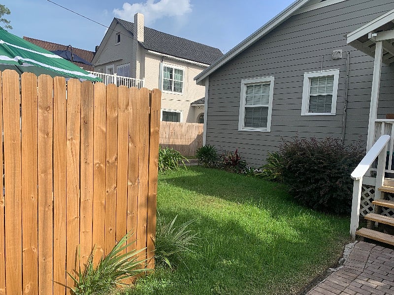 Cottage house behind main house has a fence to separate the two homes and offer more privacy.