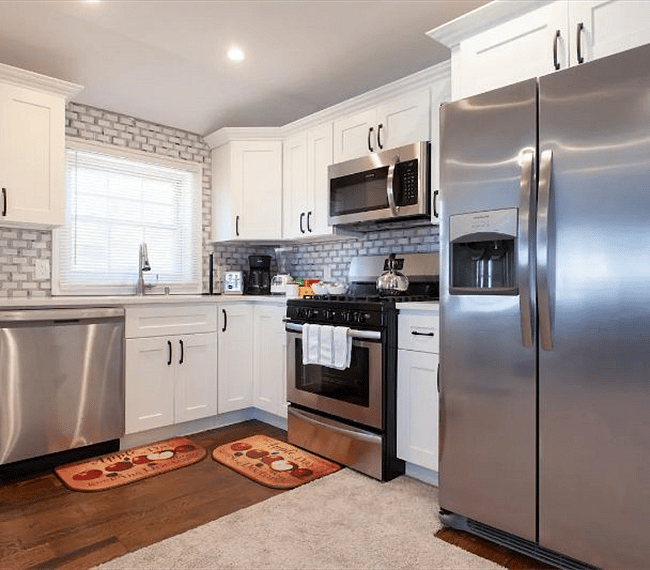 Fully stocked kitchen with microwave, dishwasher, and oven