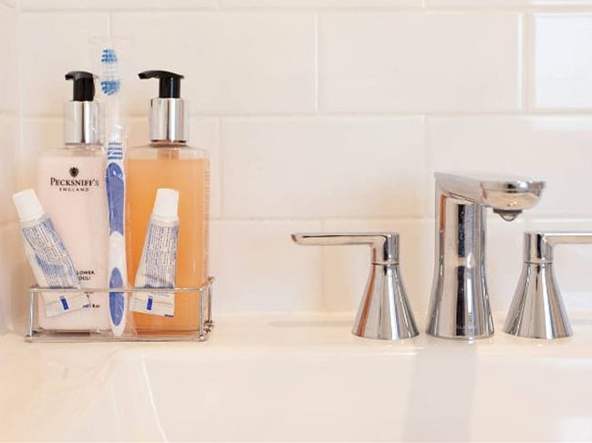 The bathroom is modern and stylish with shower, toilet and vanity