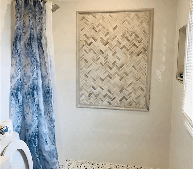 The bathroom is modern and stylish with shower, toilet and vanity