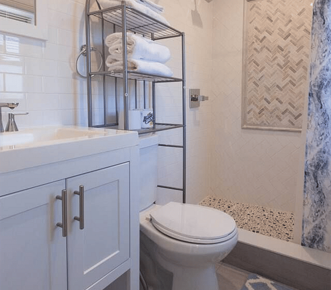 The bathroom is modern and stylish with shower, toilet and vanity