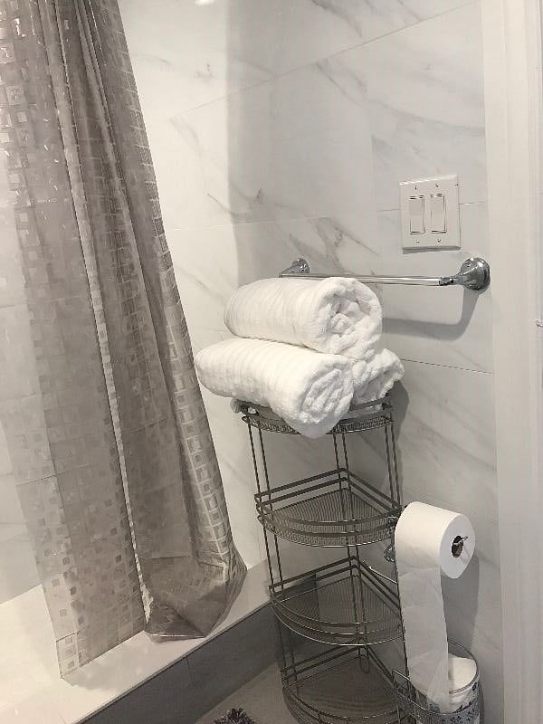 The bathroom is modern and stylish with shower, toilet and vanity