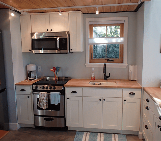 Fully stocked kitchen with fridge, microwave, cooktop, oven, coffee maker and more