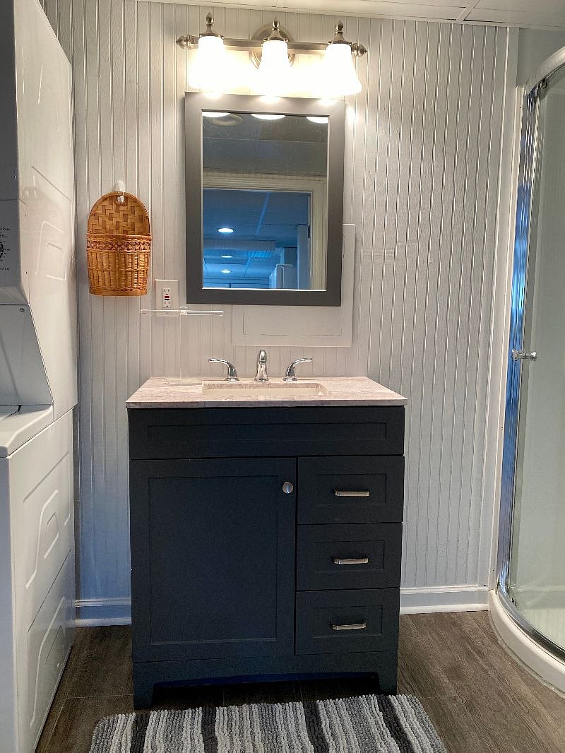 The bathroom is modern and stylish with shower, toilet and vanity