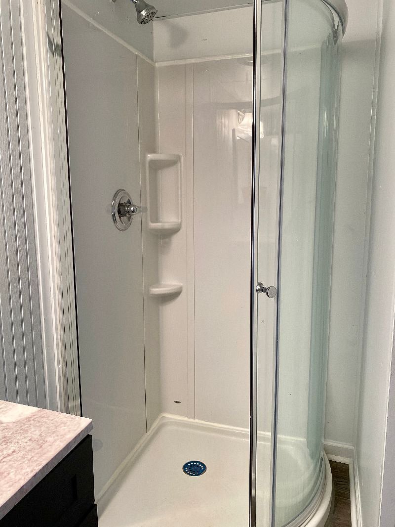 A brand new fibergalss shower features in the bathroom 