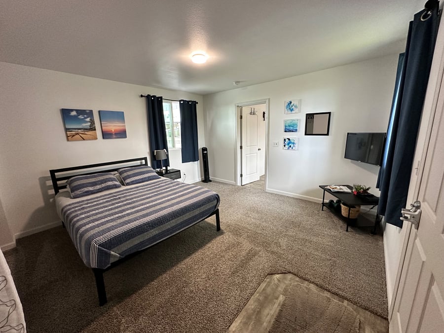 Bedroom one has a full bed, double closet space and a tv.