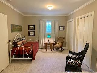 Twin bed in other end of large bedroom.