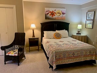 Queen bed in large bedroom